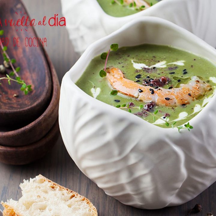 Broccoli, spinach cream soup with shrimp in a white bowls on a wooden board
